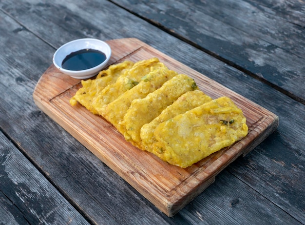 Tempe Goreng Tepung Tempe Mendoan flour fried tempeh tradtional food from Indonesia on wooden board