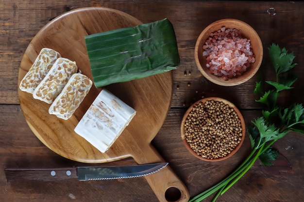 Tempe of tempeh verpakt in bananenbladeren en plakjes tempe is een traditioneel Indonesisch gerecht