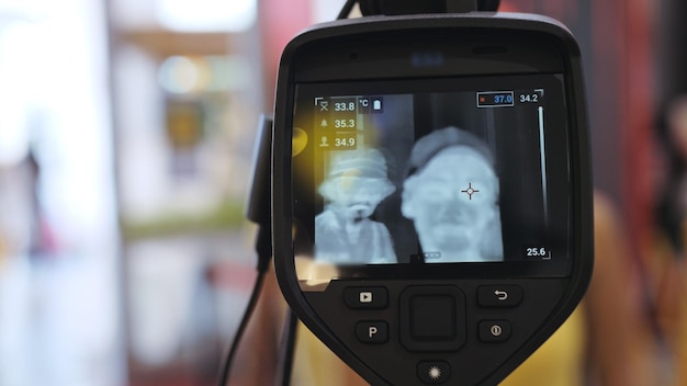 Temperature check at a supermarket grocery store with a thermal imaging camera installed Image monitoring scanner to monitor the body temperature