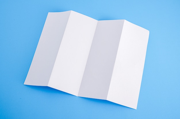 Photo template fold white paper on blue background