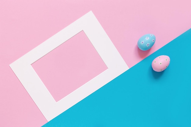 Template with Easter eggs and frame on the pink and blue background