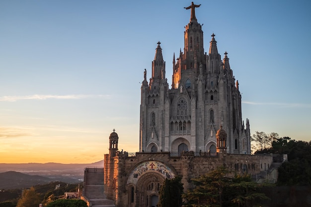 The temple of the sacred heart located on the top of mount tibidabo in barcelona spain at sunset