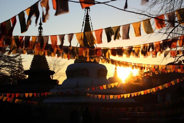 a temple with a row of flags on it