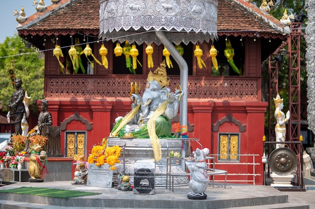 A temple with a statue of the god of the sea in front of it