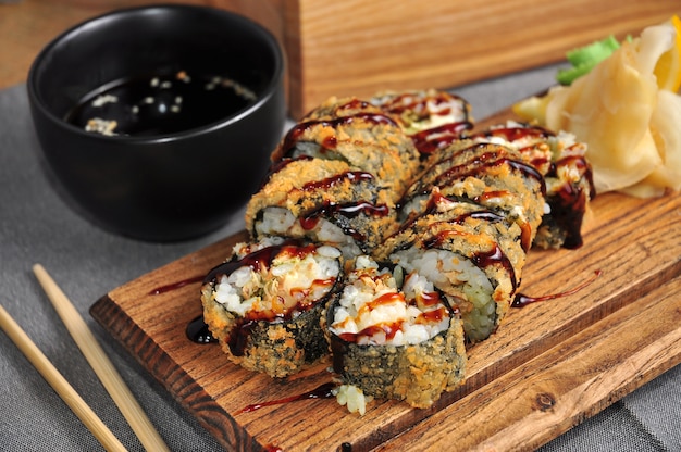 Tempura roll with salmon on a wooden Board