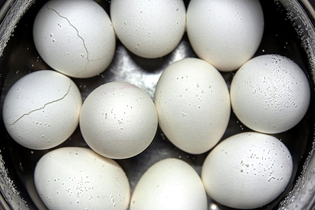 Ten chicken eggs boiled in a saucepan Closeup