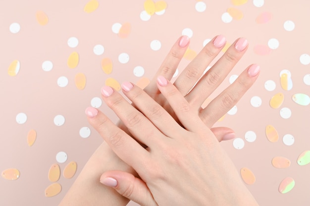 Tender female hands on beige