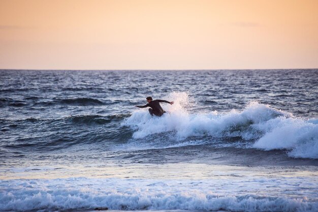 Tenerife Canary Island Spain May 11 2018 Unidentified man surfing on a large wave on Playa De Las Americas on the coast of Atlantic ocean