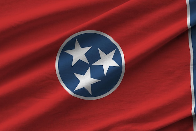 Tennessee US state flag with big folds waving close up under the studio light indoors The official symbols and colors in banner