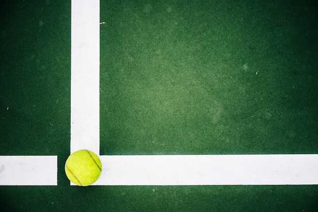 Tennis ball in corner  of tennis court