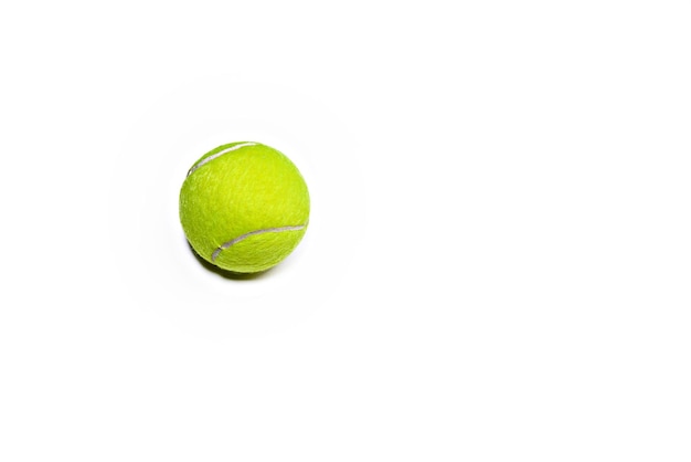 Tennis ball on a white background, in the upper left side. copy space.