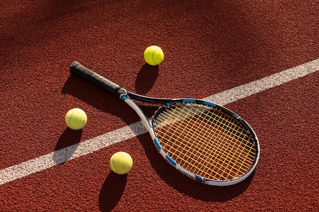 Tennis Ball with Racket on the racket in tennis court.