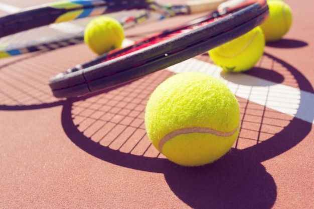 Tennis balls and racket on the grass court