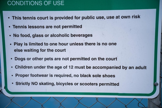tennis court rules on a sign saying no skateboards and no dogs in australia