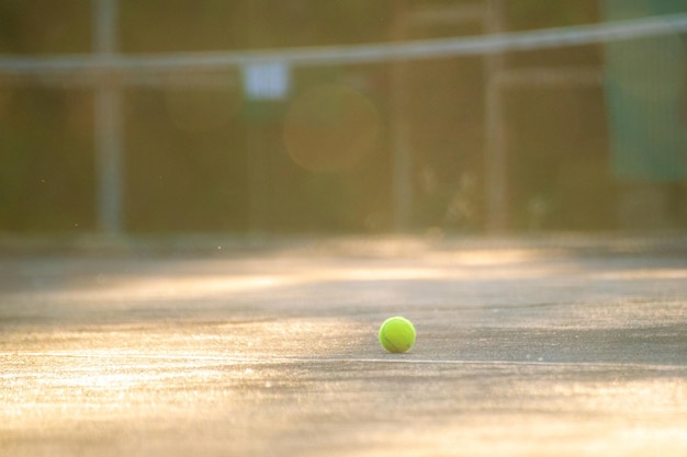 Tennis court with ball and net on a summer day under sunshines