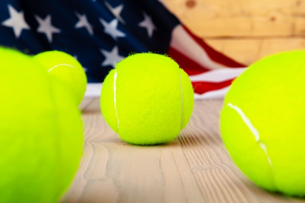 Photo tennis equipment on wooden surface close up