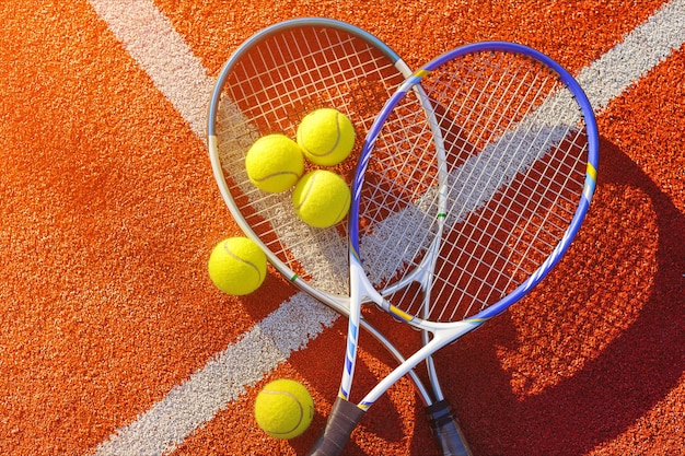 Tennis game. Tennis balls and rackets on  background.