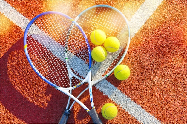 Tennis game. Tennis balls and rackets on  background.