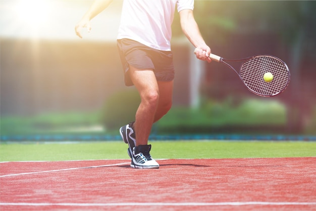 A tennis player prepares to serve a tennis ball during a match