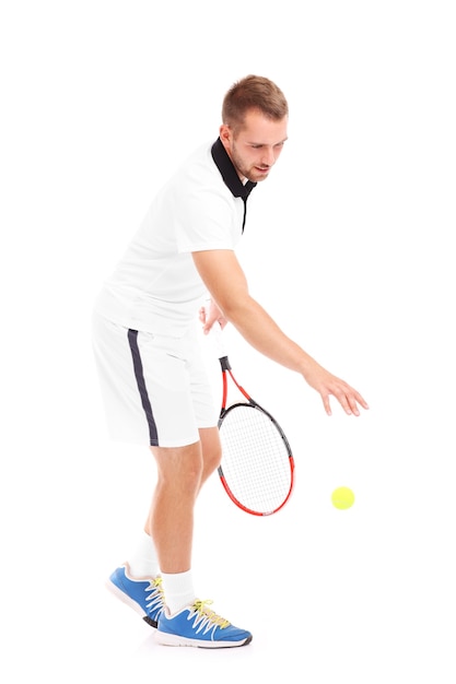 a tennis player serving a ball over white background