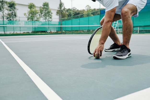 Tennis player taking ball