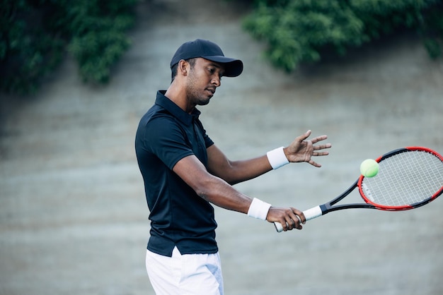 Tennis player with racket practicing outdoors