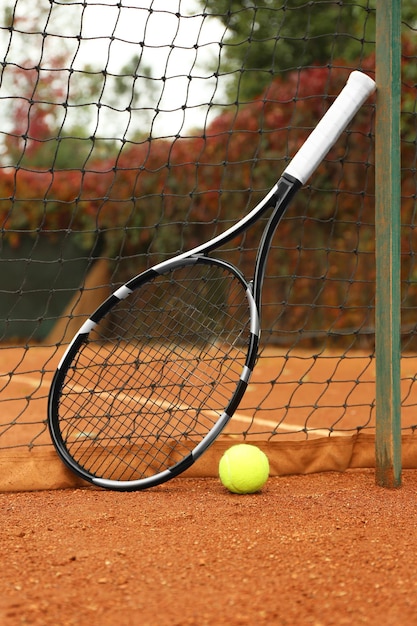 Tennis racket and ball on court