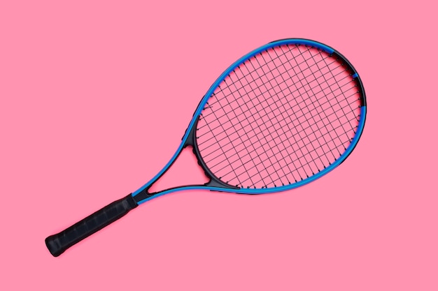 Tennis racket on pink background.