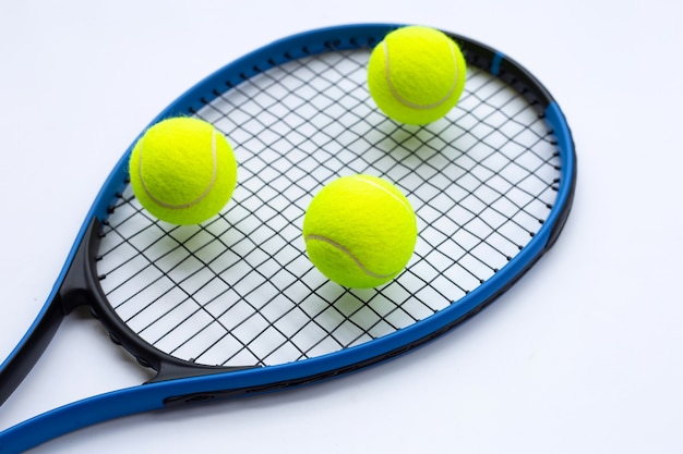 Tennis racket with balls on white