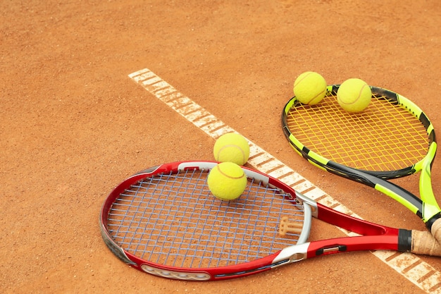 Tennisrackets met tennisballen op gravel