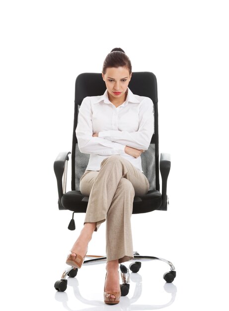 Photo tensed businesswoman sitting against white background