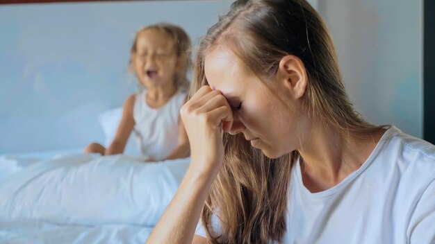 Tensed mother with daughter at home