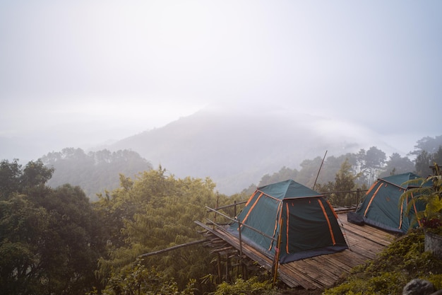 Tent on the background of the misty mountains