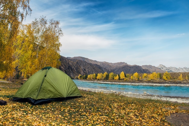 A tent on the bank of the mountain river