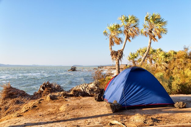 Photo tent on beach against clear blue sky