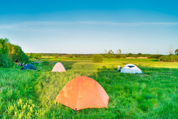 Tent camping on green grass field