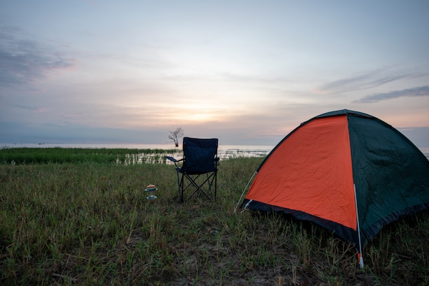 Tent and chairs by the lake 