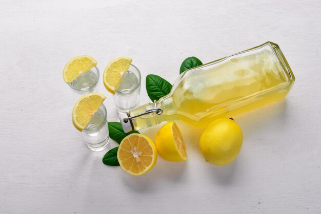 Tequila fresh lemon and lemon juice On a wooden background Top view Free space for your text