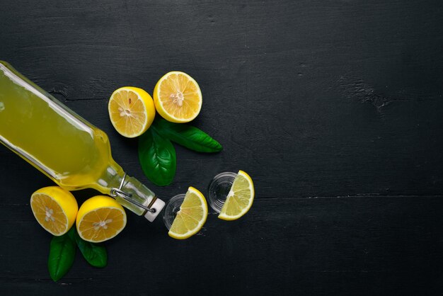 Tequila fresh lemon and lemon juice On a wooden background Top view Free space for your text