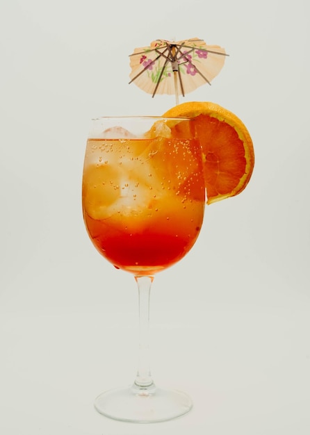 Tequila sunrise cocktail with umbrella and orange slice