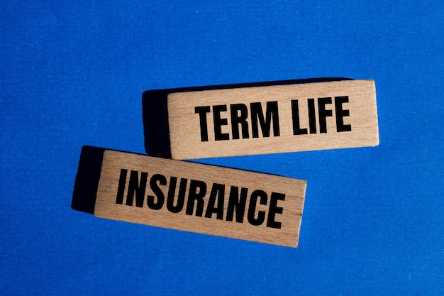 Photo term life insurance words written on wooden blocks with blue background conceptual term life insurance symbol copy space