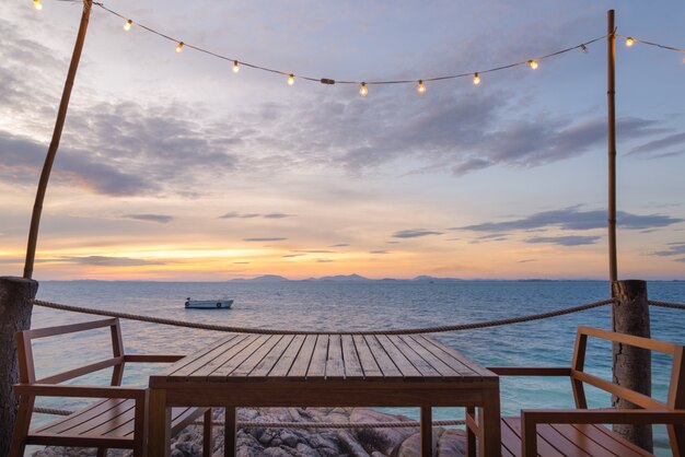 Terrace sea view with outdoor wood chairs and table