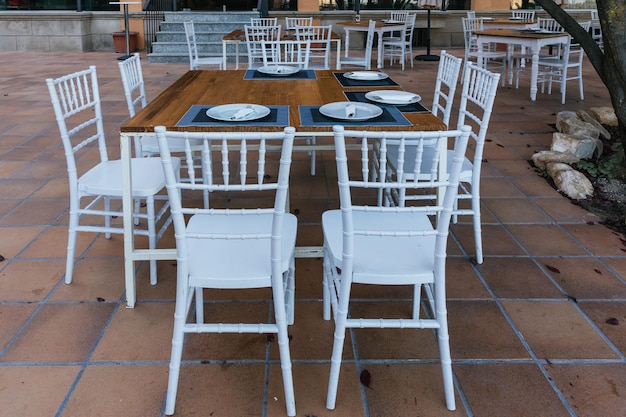 Terrace table with 8 white chairs