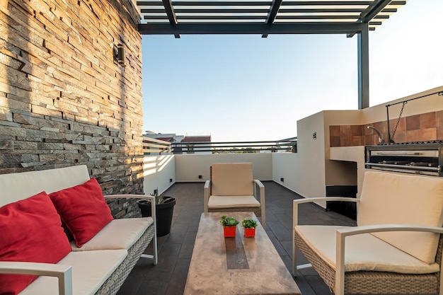 Terrace with outdoor furniture stone on one wall you can see the sky barbecue area steel pergola