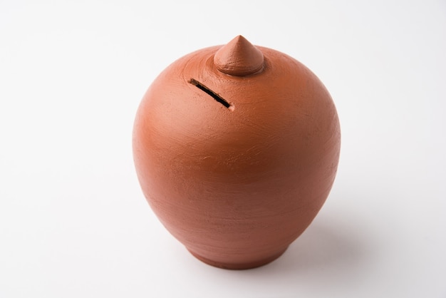 Terracotta money saving box or piggy bank, single or in group, selective focus