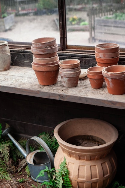 Terracotta pots and watering can in the gardener hut