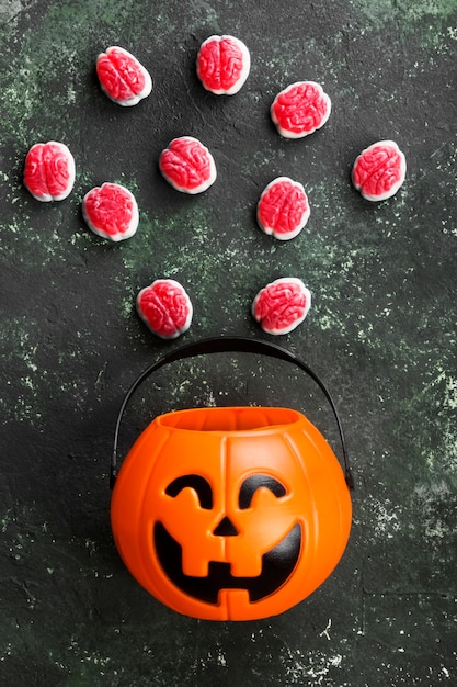 Dolci terribili (cervello) per halloween in zucca decorativa su uno sfondo scuro