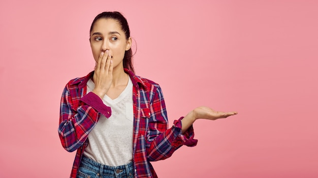 Terrified woman portrait, pink wall, emotion