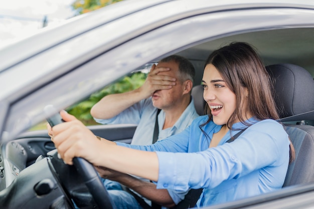 Terrified woman pressing the brake pedal , and yells in fear or frustration .