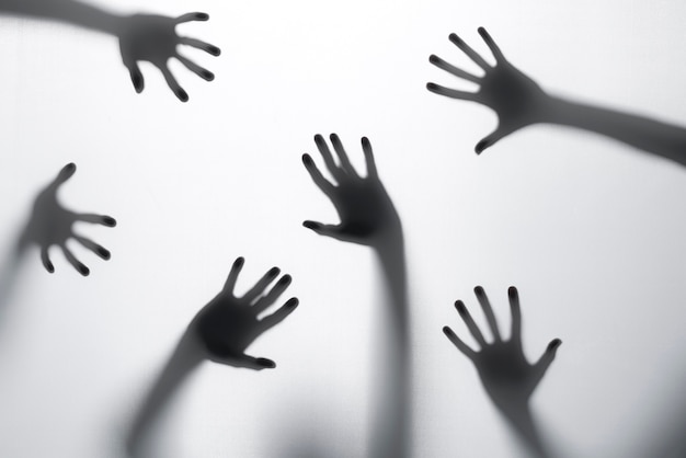 Premium Photo | Terrifying hands silhouettes in studio